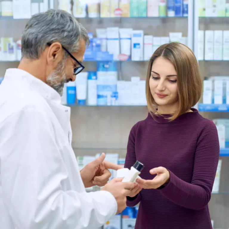 pharmacist helping woman medicine choice scaled e1719241512982